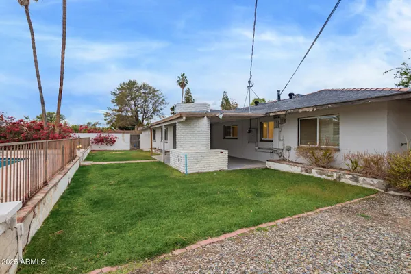 a view of a house with backyard and porch