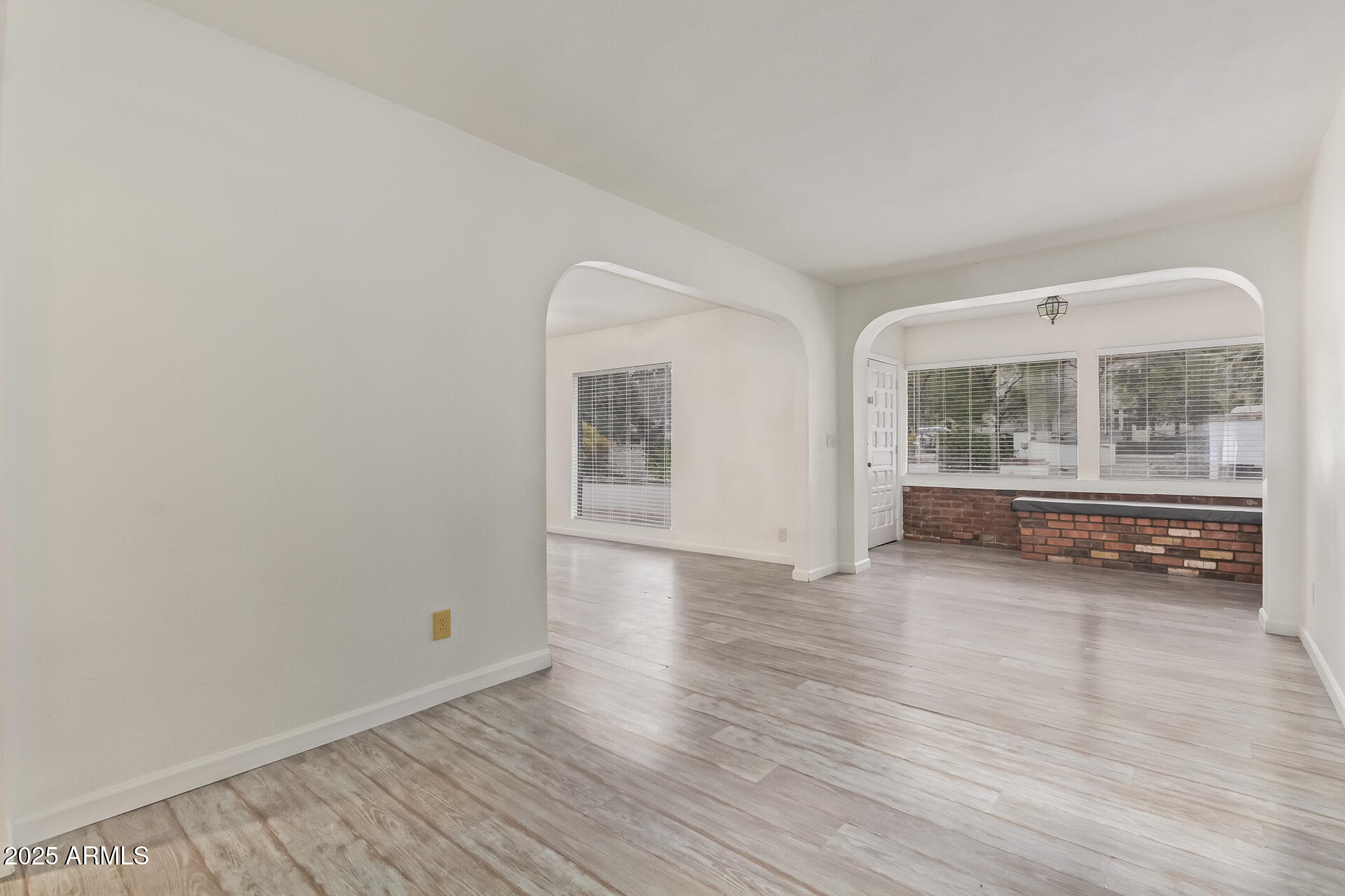 5401 East Exeter Boulevard Phoenix, AZ 85018 - Photo 8 of 47 an empty room with wooden floor and windows