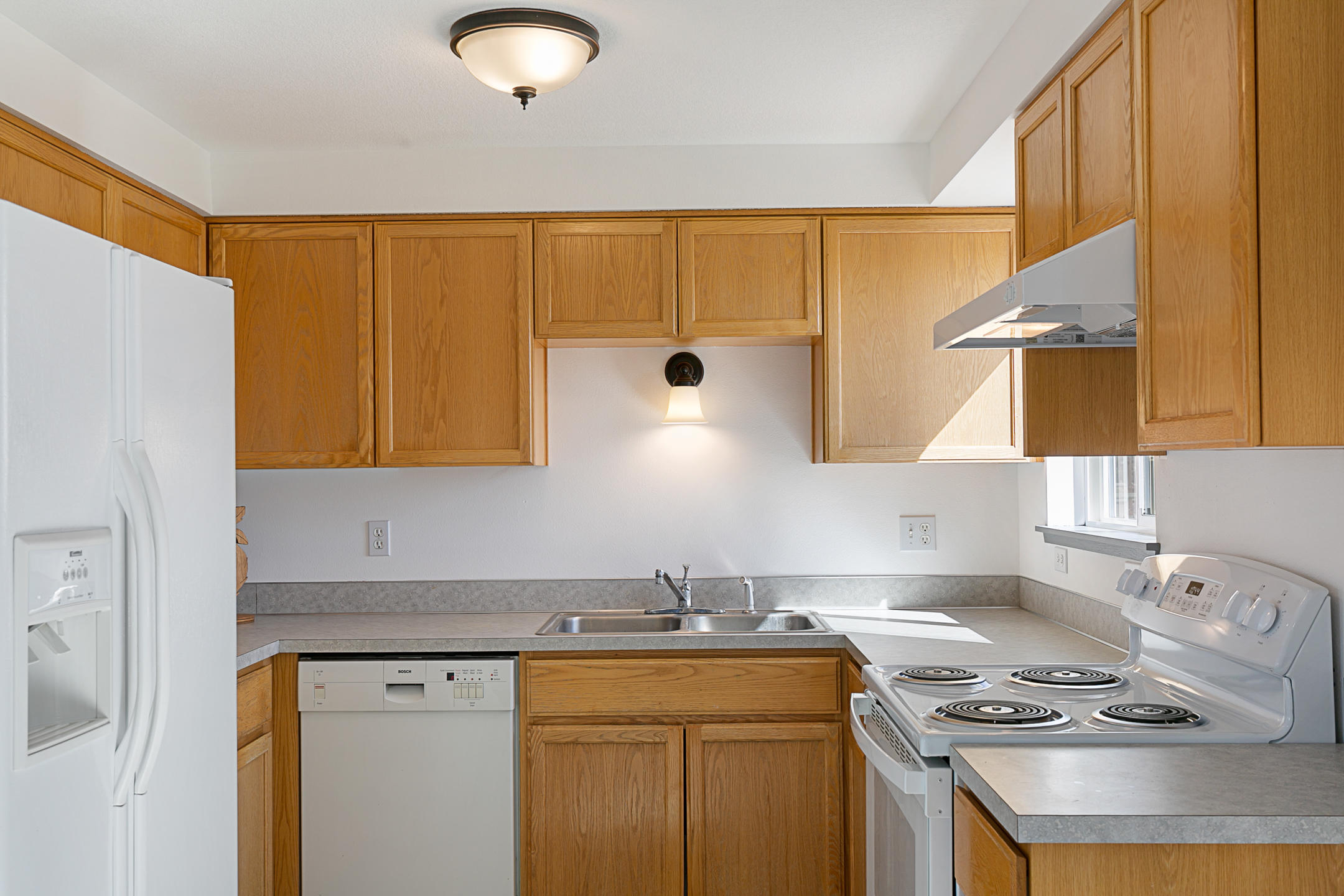 65158 Hunnell Road Bend, OR 97703 - Photo 7 of 31 a kitchen with stainless steel appliances granite countertop a sink stove and cabinets