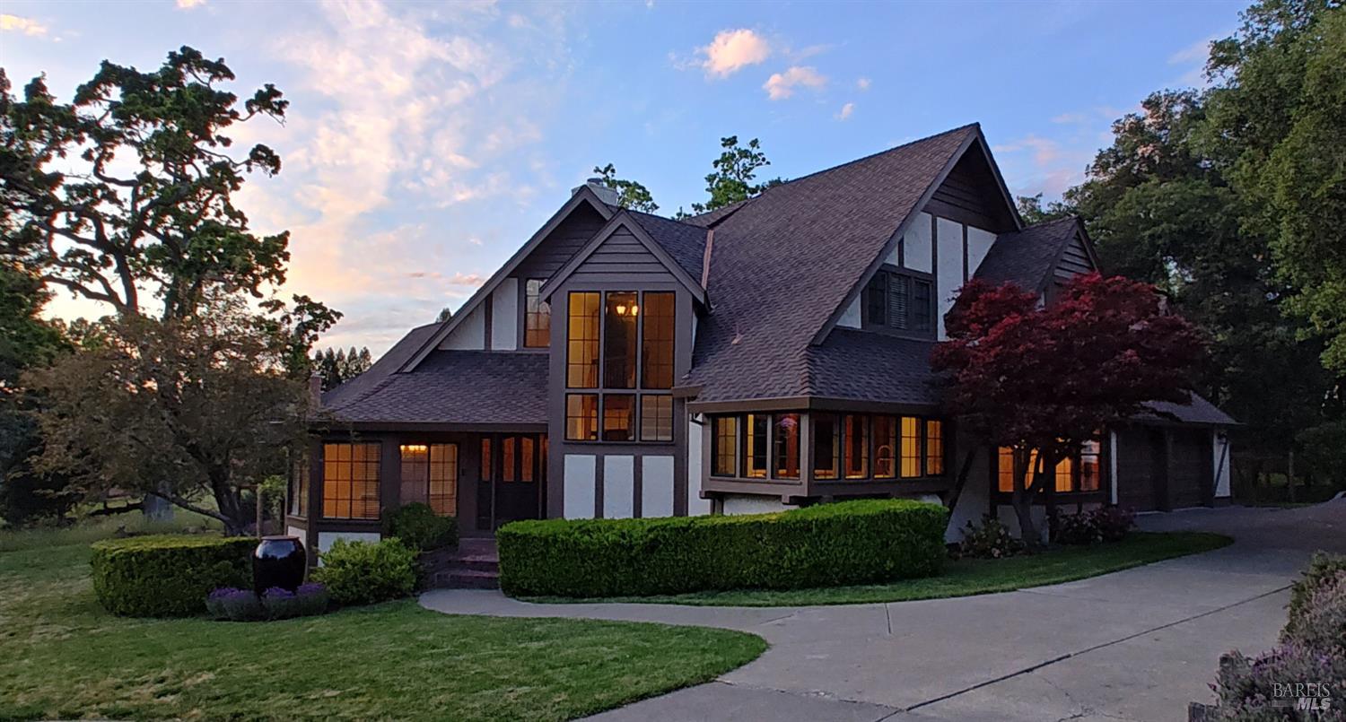 a front view of a house with a garden