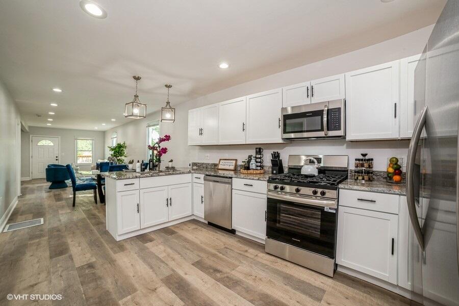 1132 Cleveland Street Hammond, IN 46320 - Photo 11 of 30 a kitchen with microwave a stove and cabinets