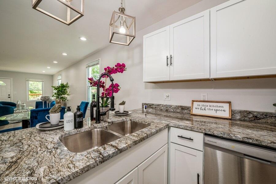 1132 Cleveland Street Hammond, IN 46320 - Photo 10 of 30 a kitchen with granite countertop a sink flowers and cabinets