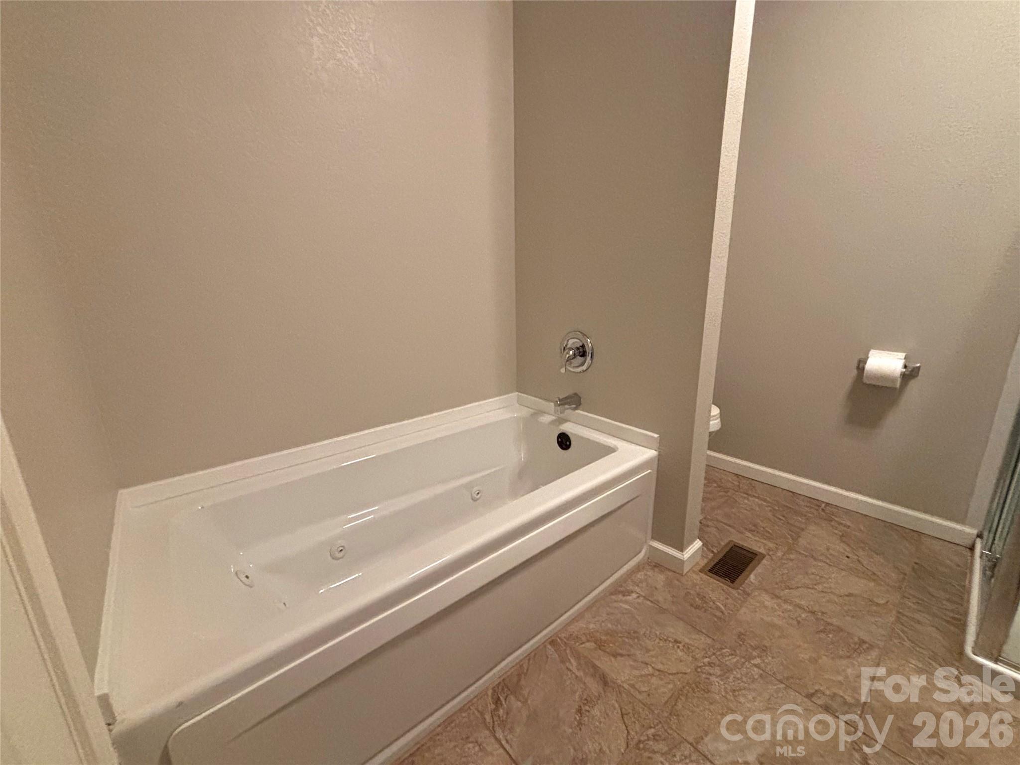250 Duckett Cove Road Waynesville, NC 28786 - Photo 11 of 23 a bathroom with a bathtub and shower