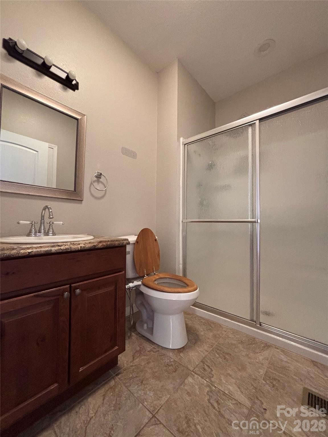 250 Duckett Cove Road Waynesville, NC 28786 - Photo 14 of 23 a bathroom with a toilet a sink and mirror