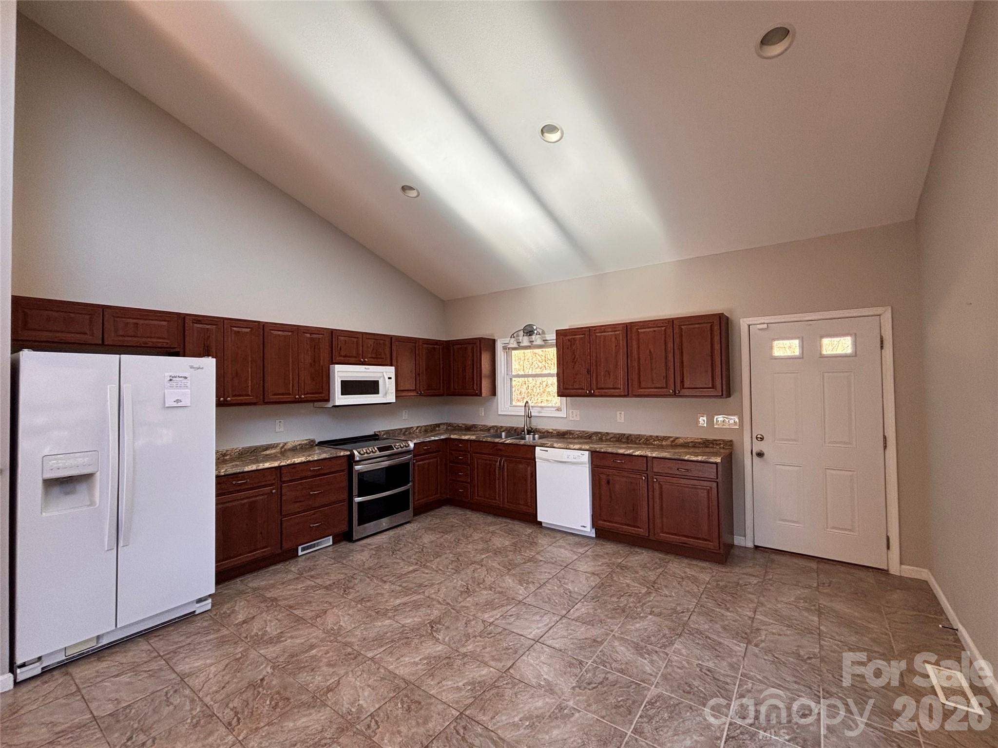 250 Duckett Cove Road Waynesville, NC 28786 - Photo 15 of 23 a large kitchen with cabinets and stainless steel appliances