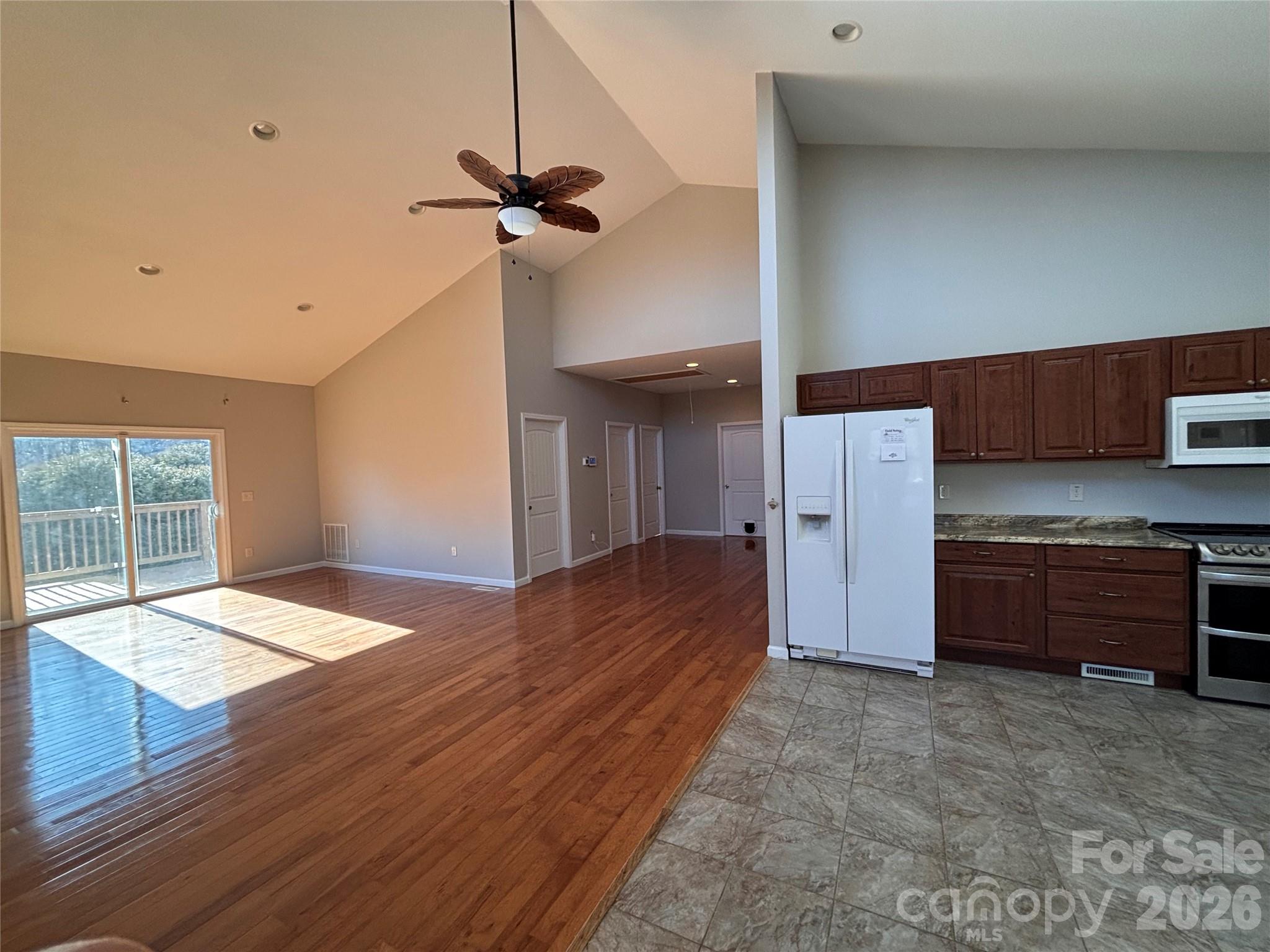 250 Duckett Cove Road Waynesville, NC 28786 - Photo 16 of 23 a bed room with a bed and a ceiling fan