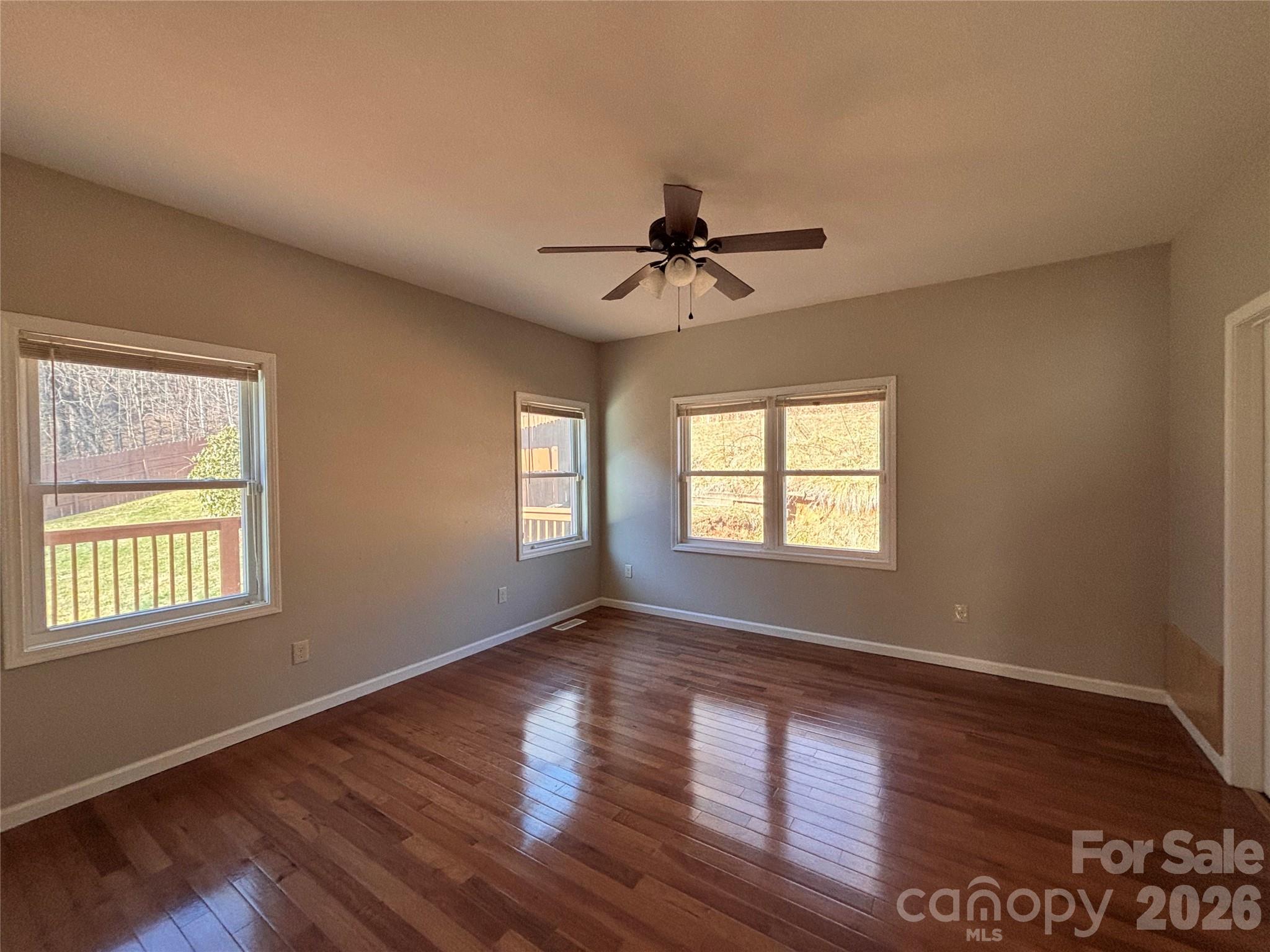 250 Duckett Cove Road Waynesville, NC 28786 - Photo 7 of 23 a view of an empty room with wooden floor and a window
