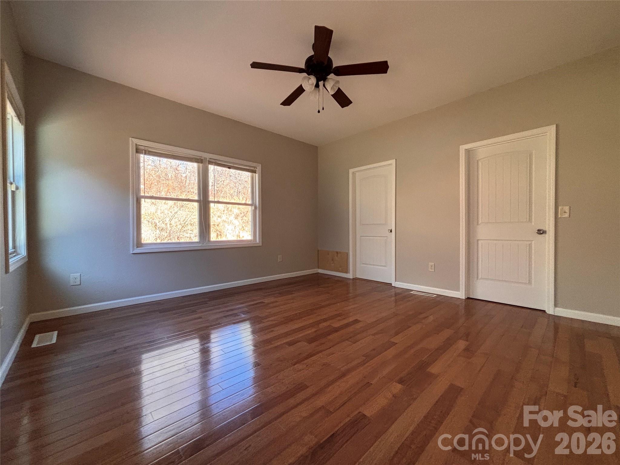 250 Duckett Cove Road Waynesville, NC 28786 - Photo 8 of 23 a view of an empty room with wooden floor and a window