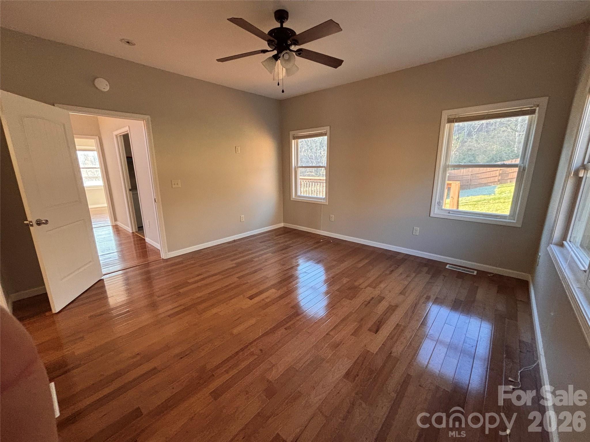 250 Duckett Cove Road Waynesville, NC 28786 - Photo 9 of 23 a view of an empty room with wooden floor and a window