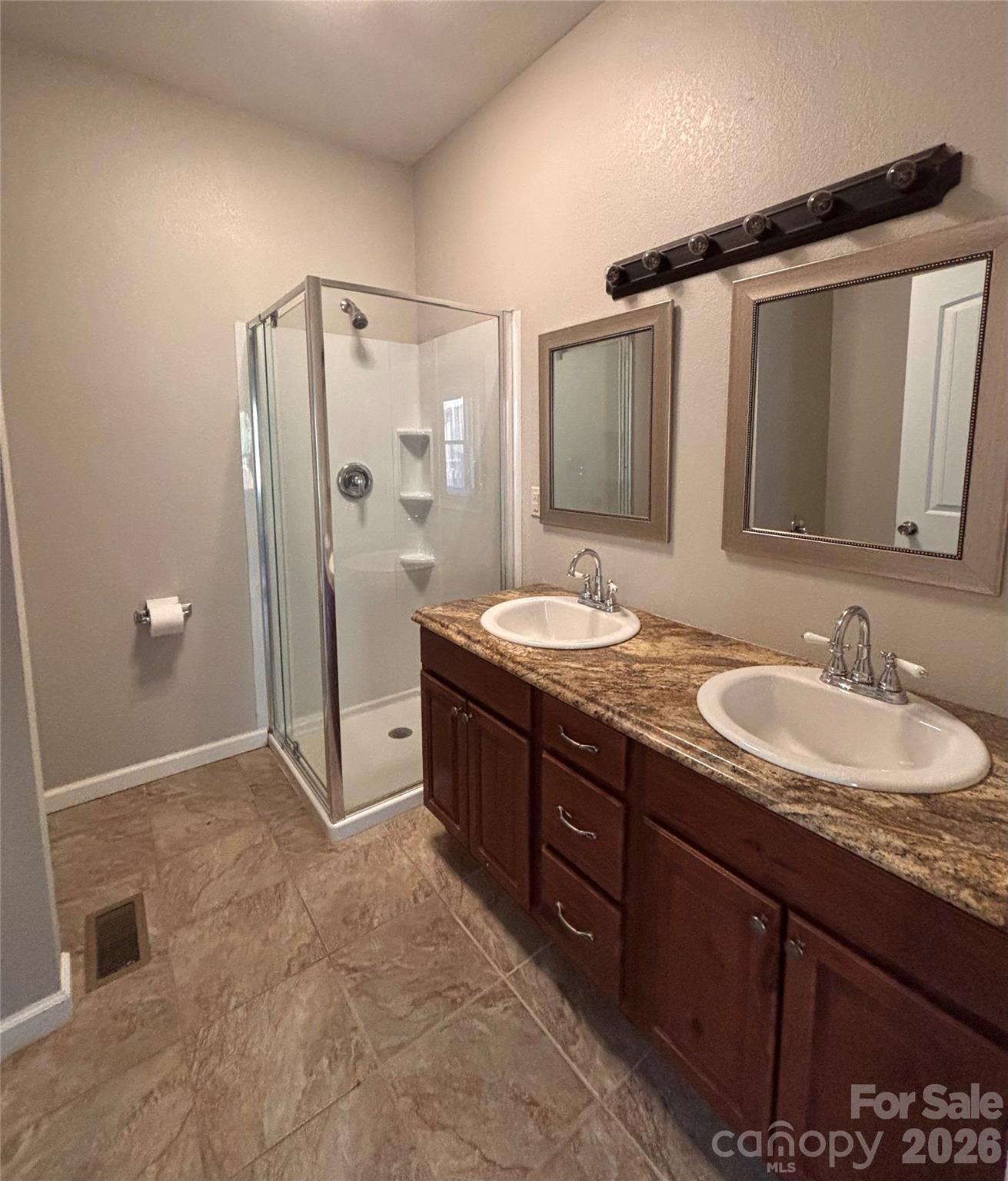 250 Duckett Cove Road Waynesville, NC 28786 - Photo 10 of 23 a spacious bathroom with a granite countertop sink mirror and shower