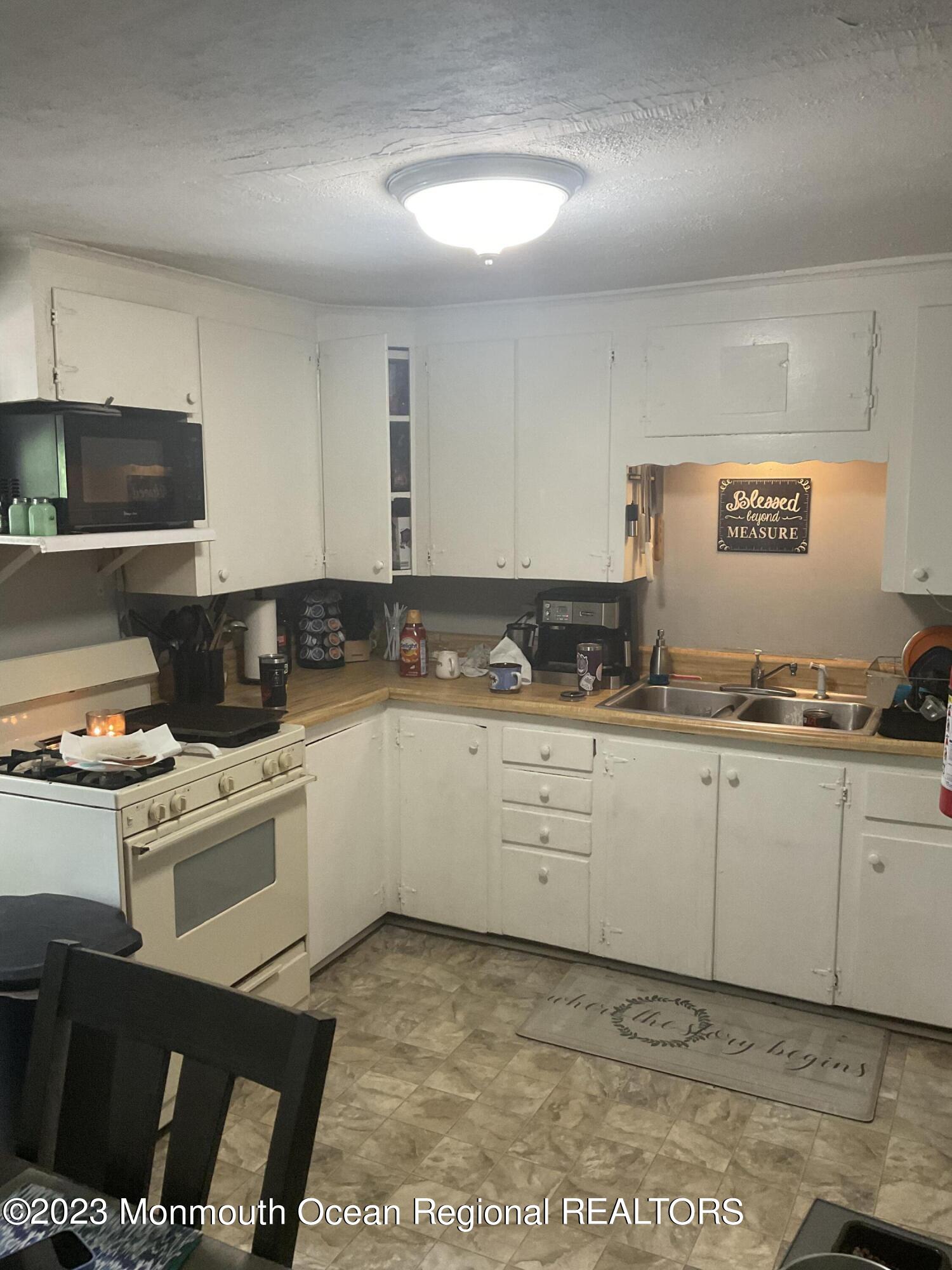 87 Cedarhurst Road Brick, NJ 08723 - Photo 6 of 14 a kitchen with a cabinets and a stove top oven
