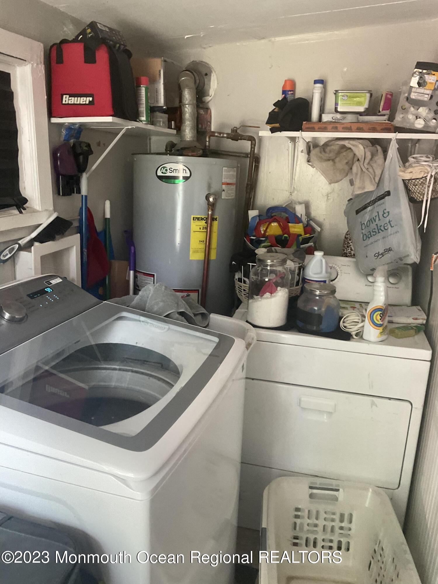 87 Cedarhurst Road Brick, NJ 08723 - Photo 7 of 14 a utility room with sink dryer and bicycles