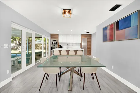 a view of a dining room with furniture and wooden floor