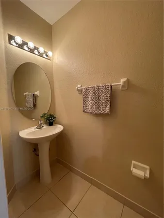 a bathroom with a sink mirror and toilet