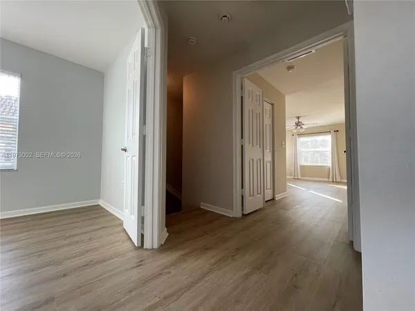 a view of a hallway with wooden floor