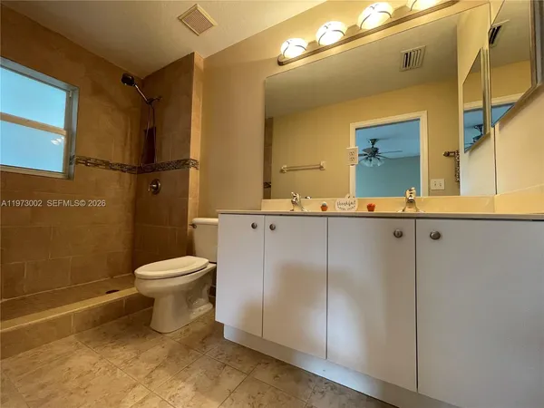 a bathroom with a sink a toilet and mirror