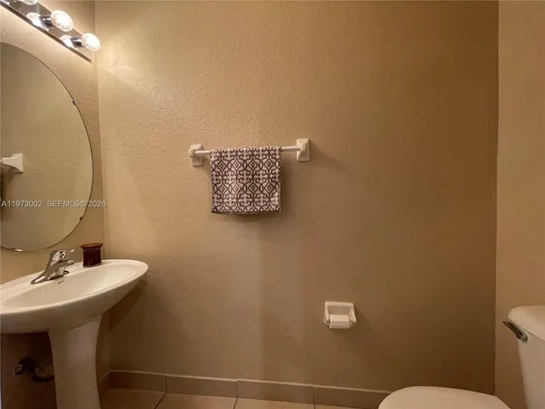 a bathroom with a sink mirror and toilet