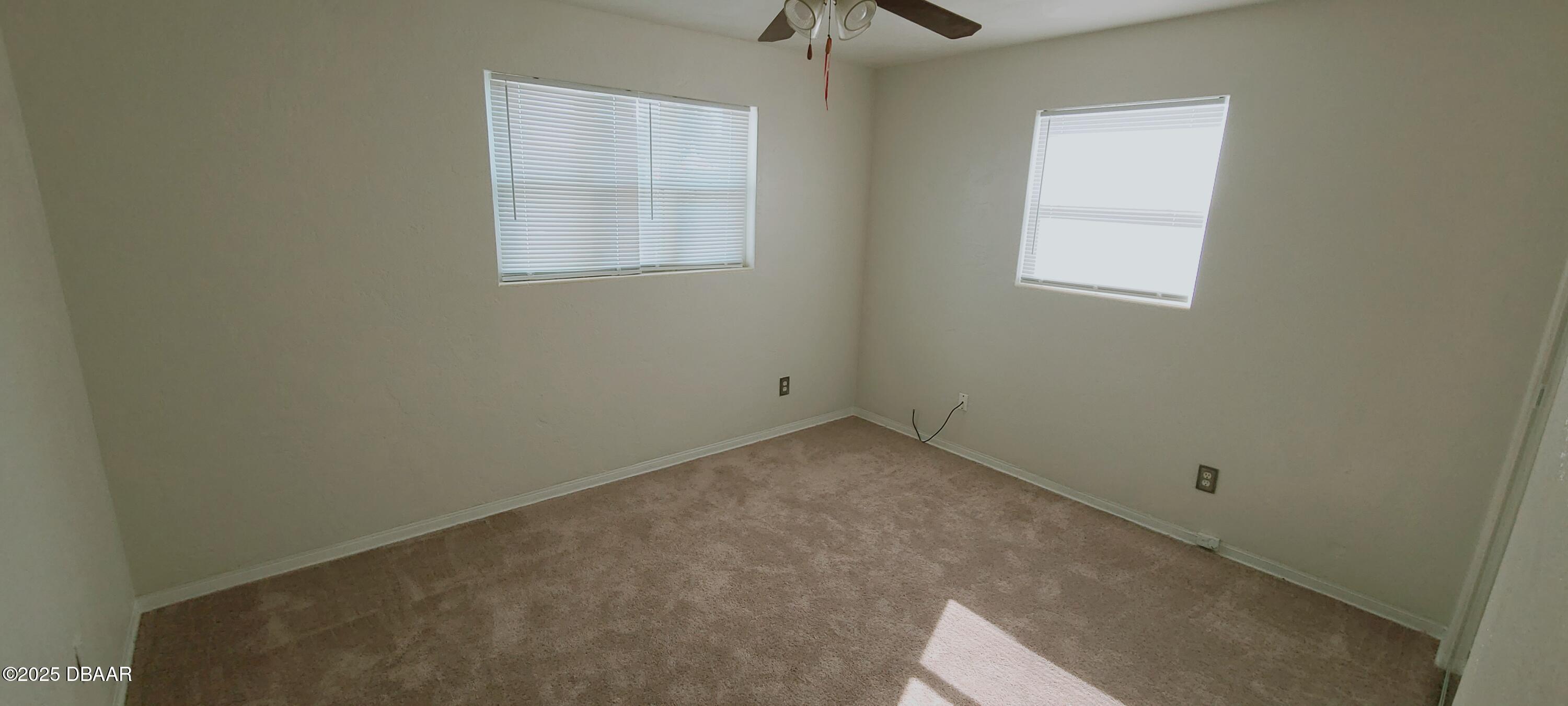 54 Seaside Drive Ormond Beach, FL 32176 - Photo 8 of 12 an empty room with windows