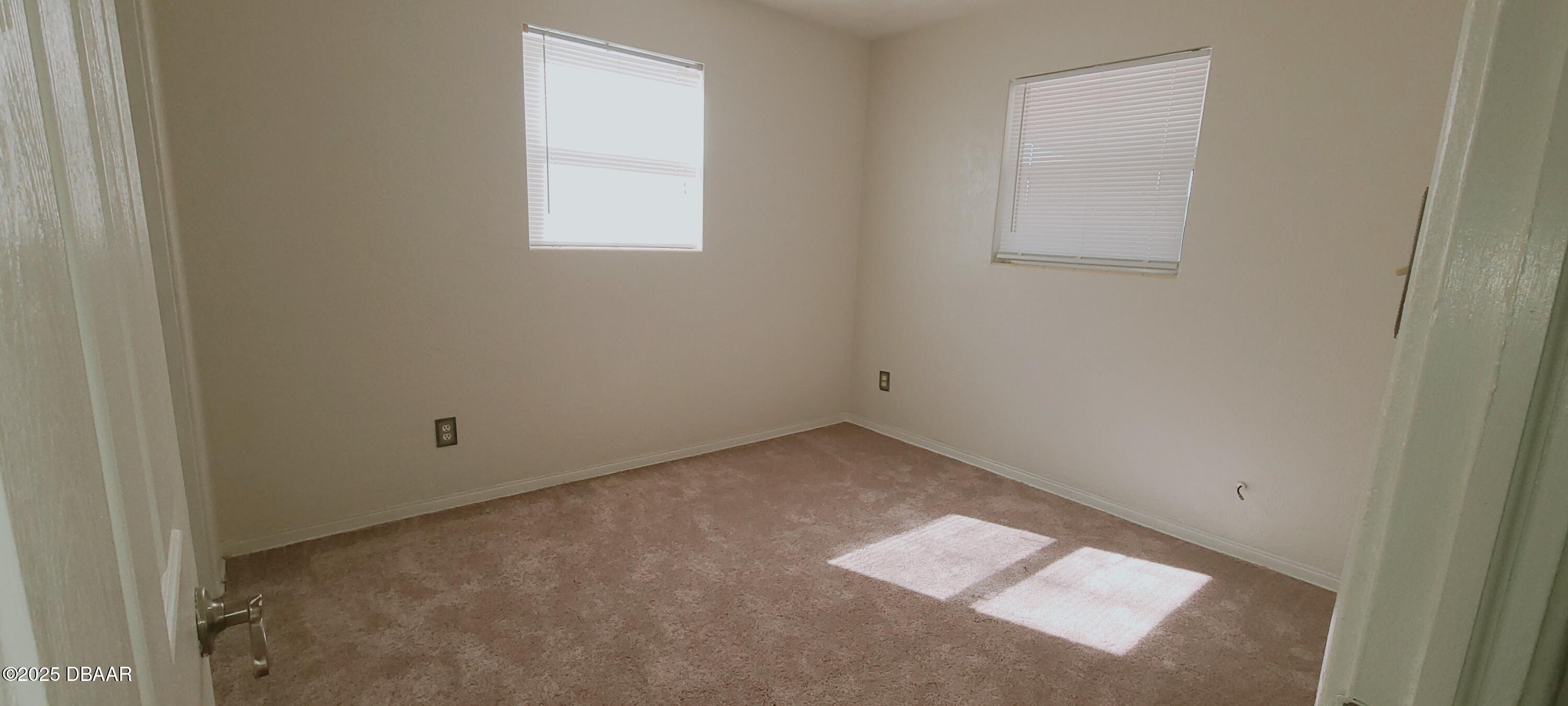 54 Seaside Drive Ormond Beach, FL 32176 - Photo 10 of 12 an empty room with a window