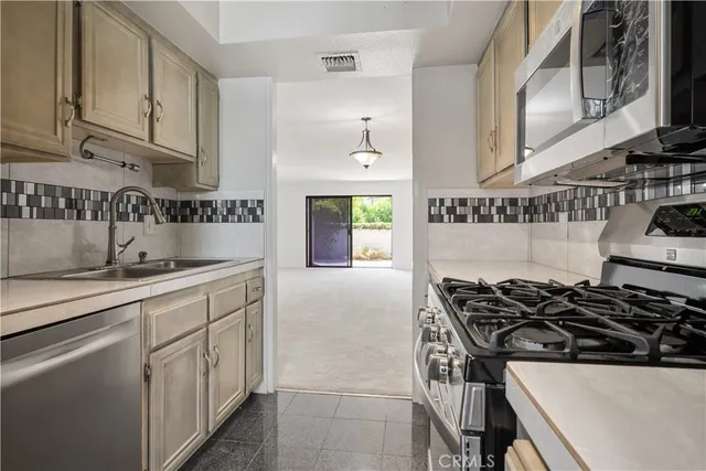 a stove top oven sitting inside of a kitchen
