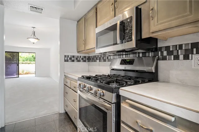 a kitchen with cabinets a stove and a sink