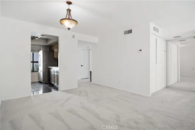 an empty room with closet and windows