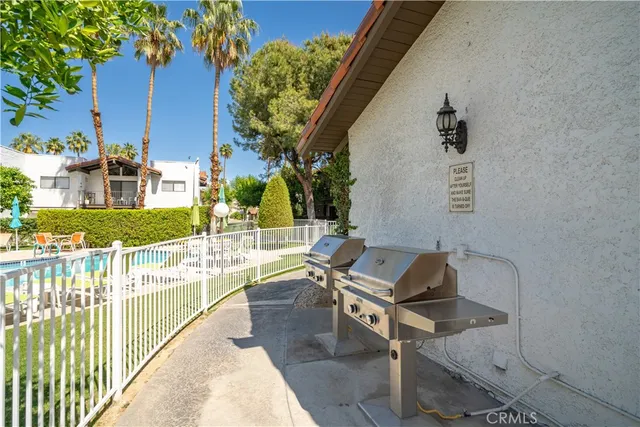 a view of a house with a fountain and a yard