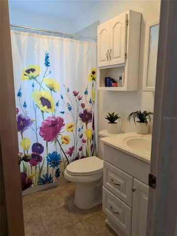 a bathroom with a sink mirror vanity and toilet