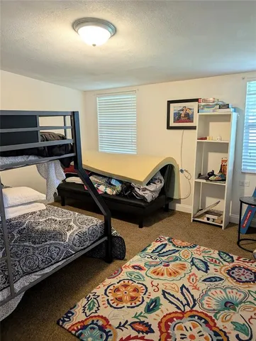 a bedroom with bed and a window