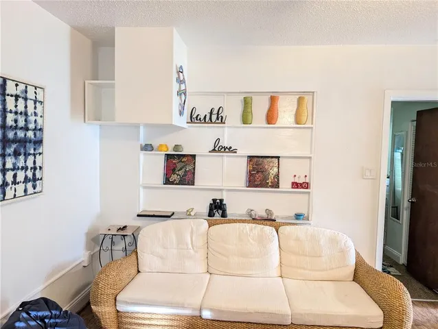 a living room with furniture and white walls