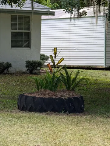 a view of a chair and table in backyard