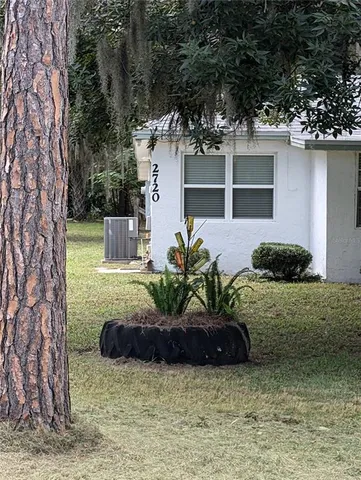 a view of a house with a yard and a garden