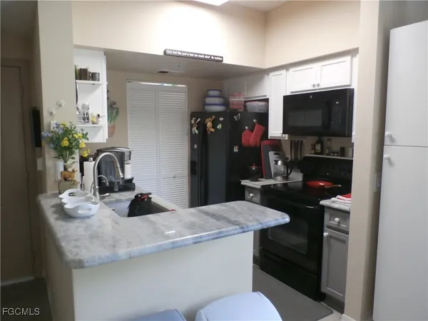 a kitchen with a sink and a refrigerator