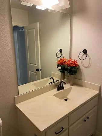 a bathroom with a sink vanity and a mirror
