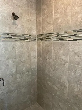 a bathroom with a shower and a window