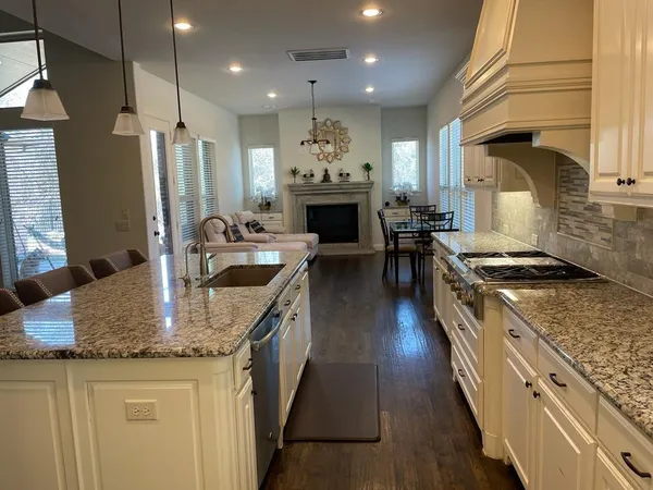 a kitchen with sink stove and refrigerator