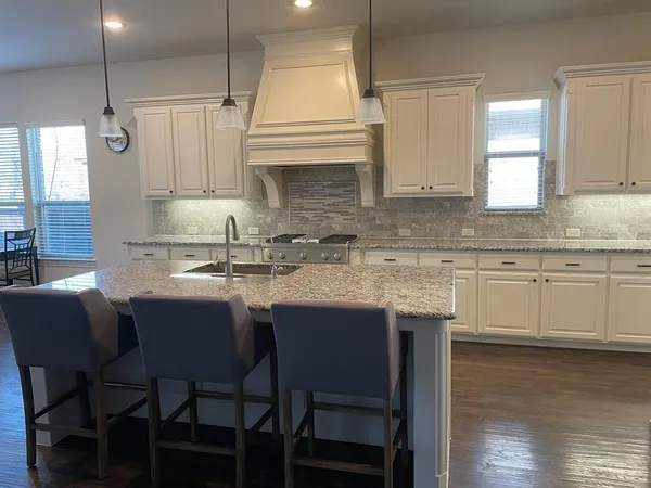 a kitchen with a sink cabinets and window