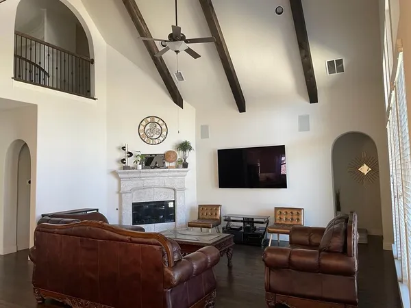 a living room with furniture a fireplace and a flat screen tv