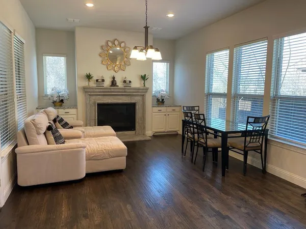 a living room with furniture a fireplace and a chandelier