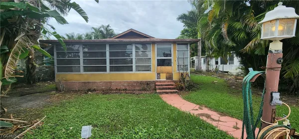 a view of a house with a swimming pool and porch with furniture