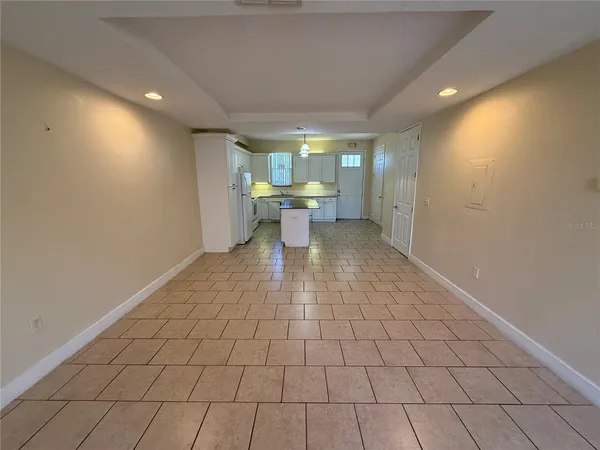 a kitchen with a sink a refrigerator a microwave and cabinets