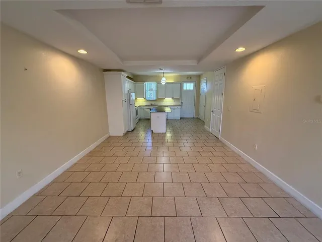 a kitchen with a sink a refrigerator a microwave and cabinets