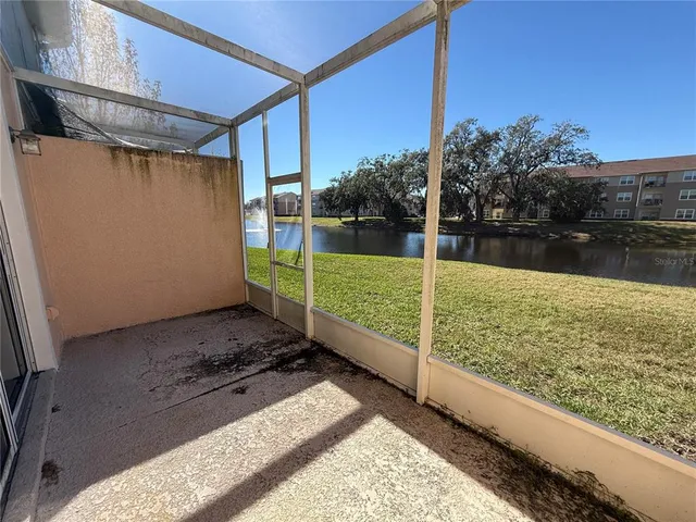 a view of an house with backyard space and balcony