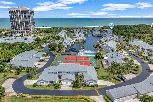 an aerial view of a house with a swimming pool outdoor seating and yard