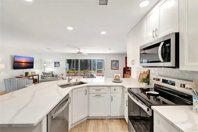 a kitchen with a sink stove and microwave