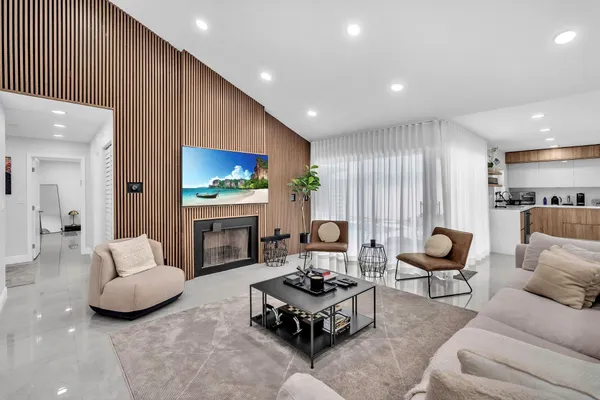 a living room with furniture fireplace and window