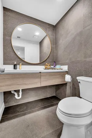 a bathroom with a sink mirror and vanity