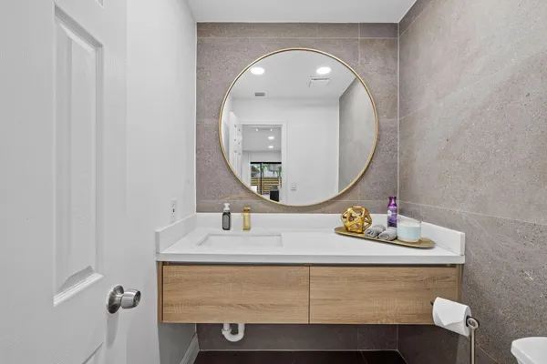 a bathroom with a sink a mirror and a toilet