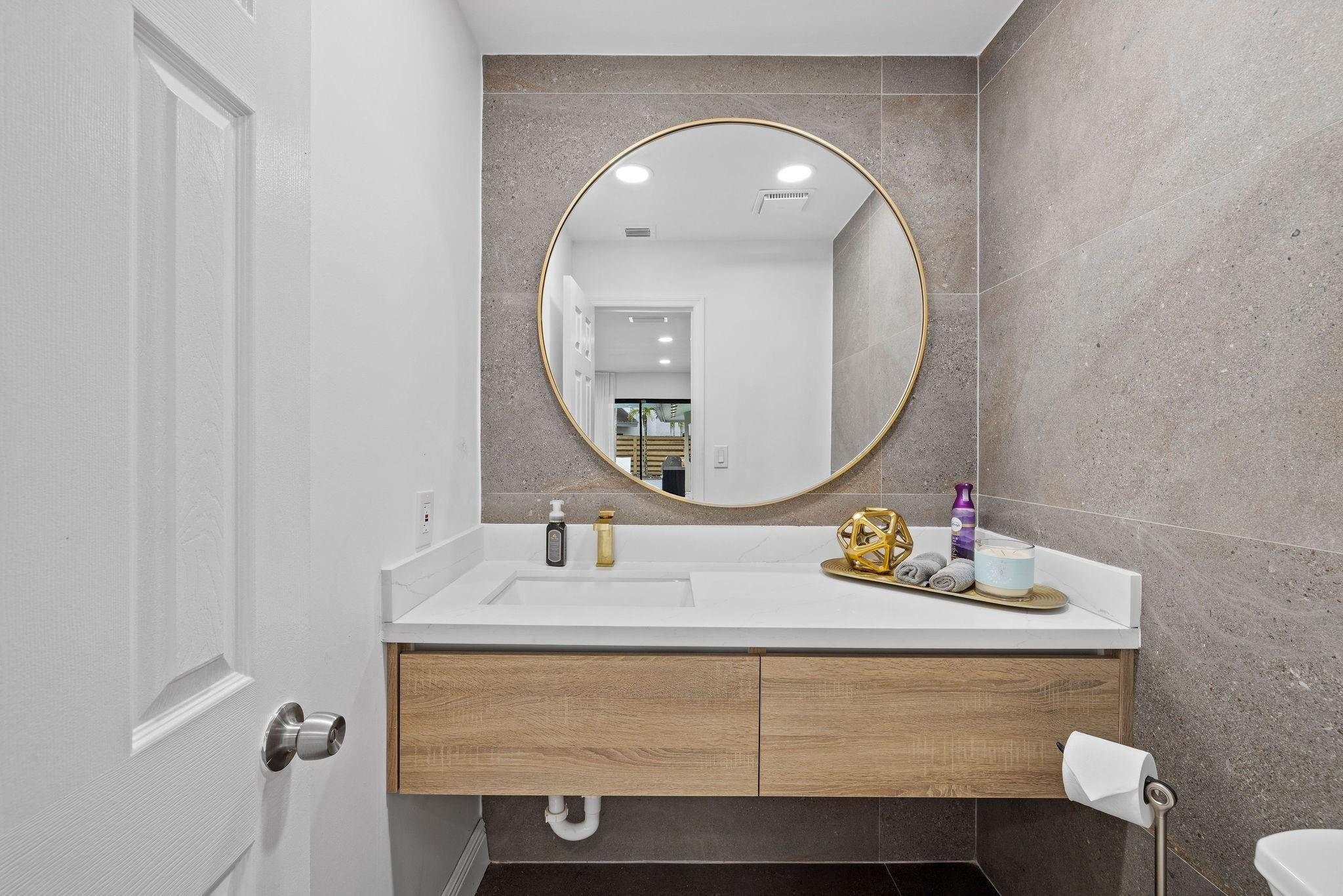 136 Greens Road Hollywood, FL 33021 - Photo 16 of 32 a bathroom with a sink mirror and vanity