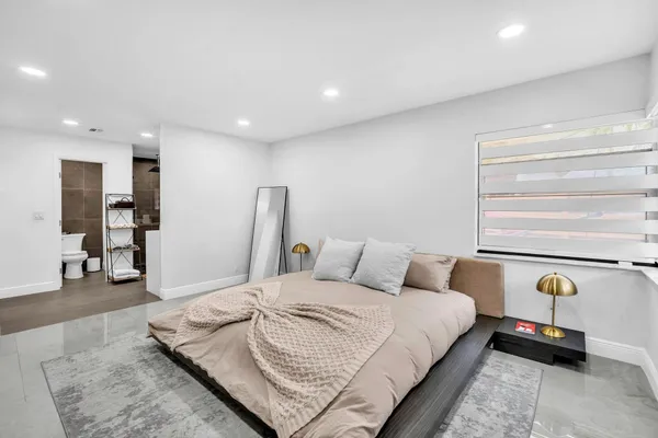 a bedroom with a bed and a window